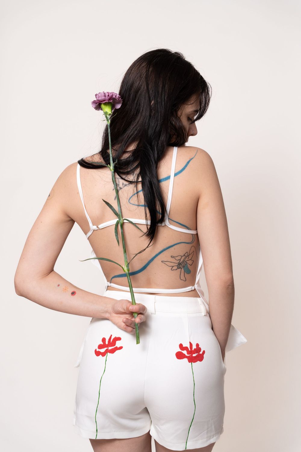 Editorial fashion portrait showcasing hand-painted garments with minimalist styling, artistic details, and expressive visual storytelling.