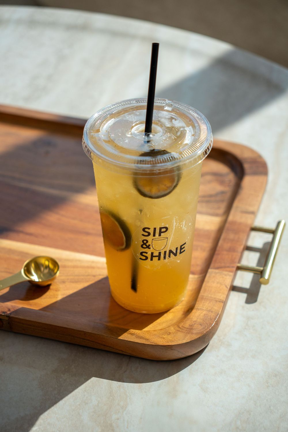 Branded citrus beverage captured with natural light, emphasizing freshness, premium ingredients, and modern café presentation.