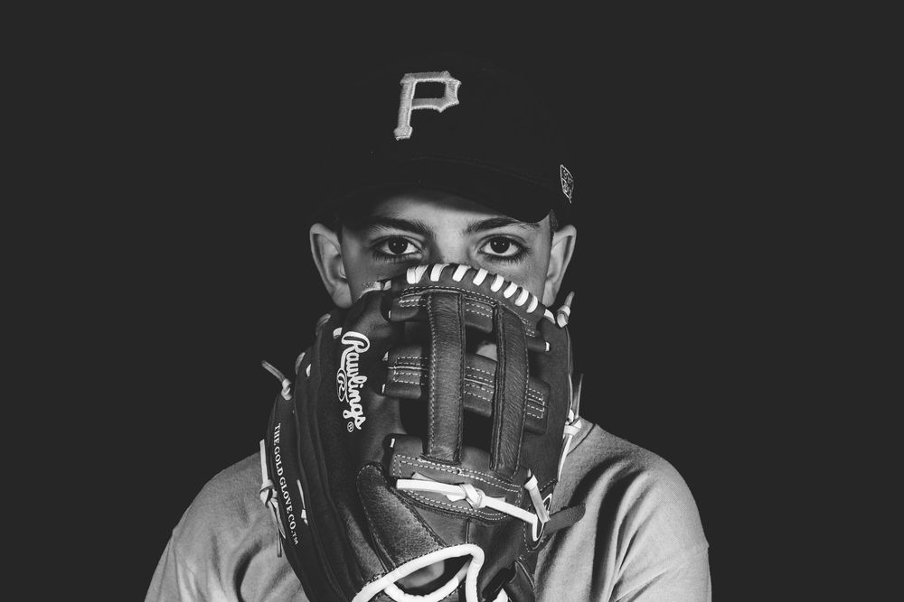 Black and white baseball photos show a Pittsburgh Pirates player in action during a game.