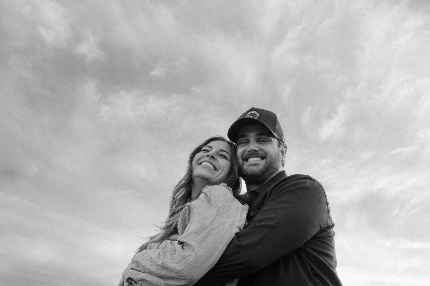 Couple photo session at sunset in the Greater Phoenix area, capturing a romantic moment with warm, glowing desert light.