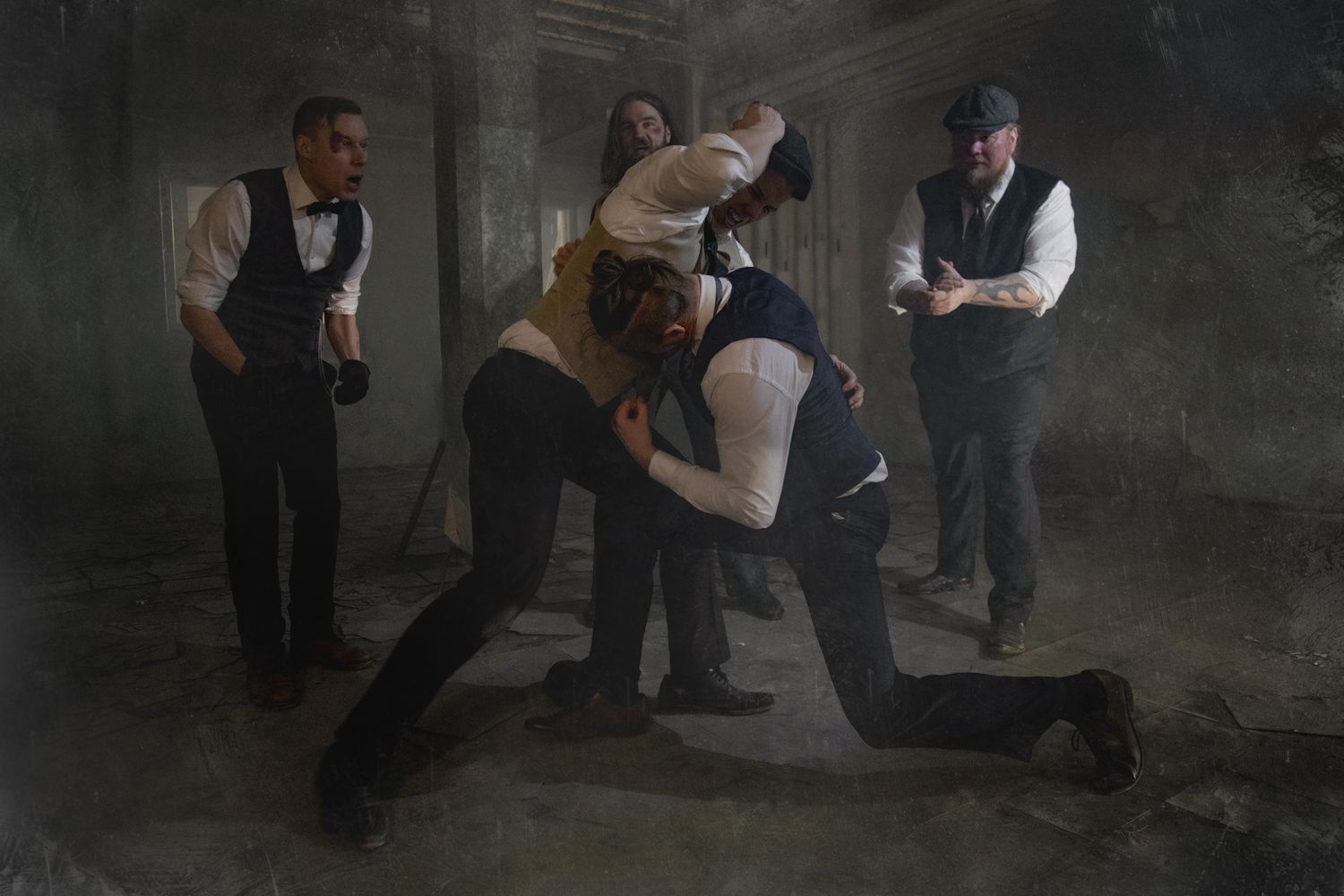 Dramatic monochrome scene of vintage-dressed figures in a fight sequence with moody lighting.