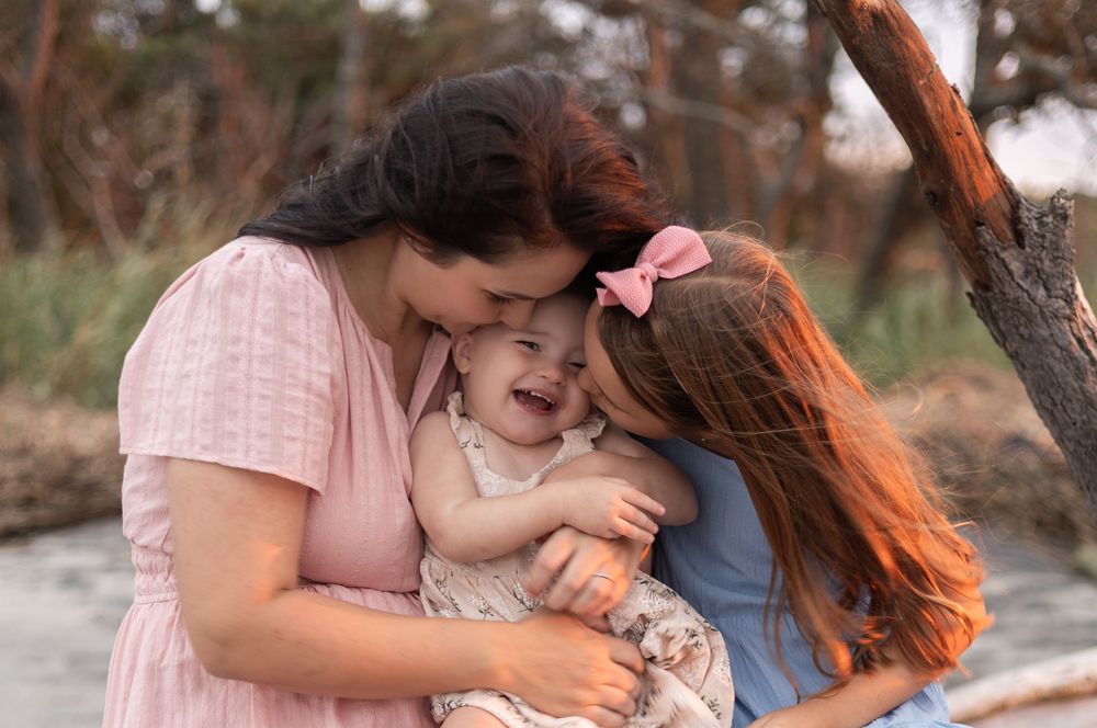 A series of tender family moments captured outdoors showing affectionate embraces and loving interactions.