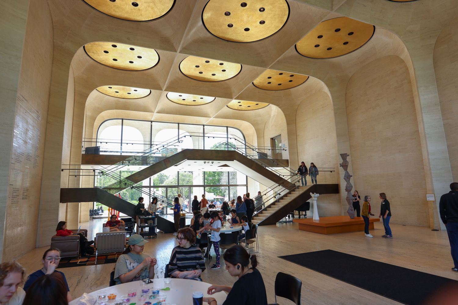 Modern architectural interior space with circular ceiling lights and curved design elements.