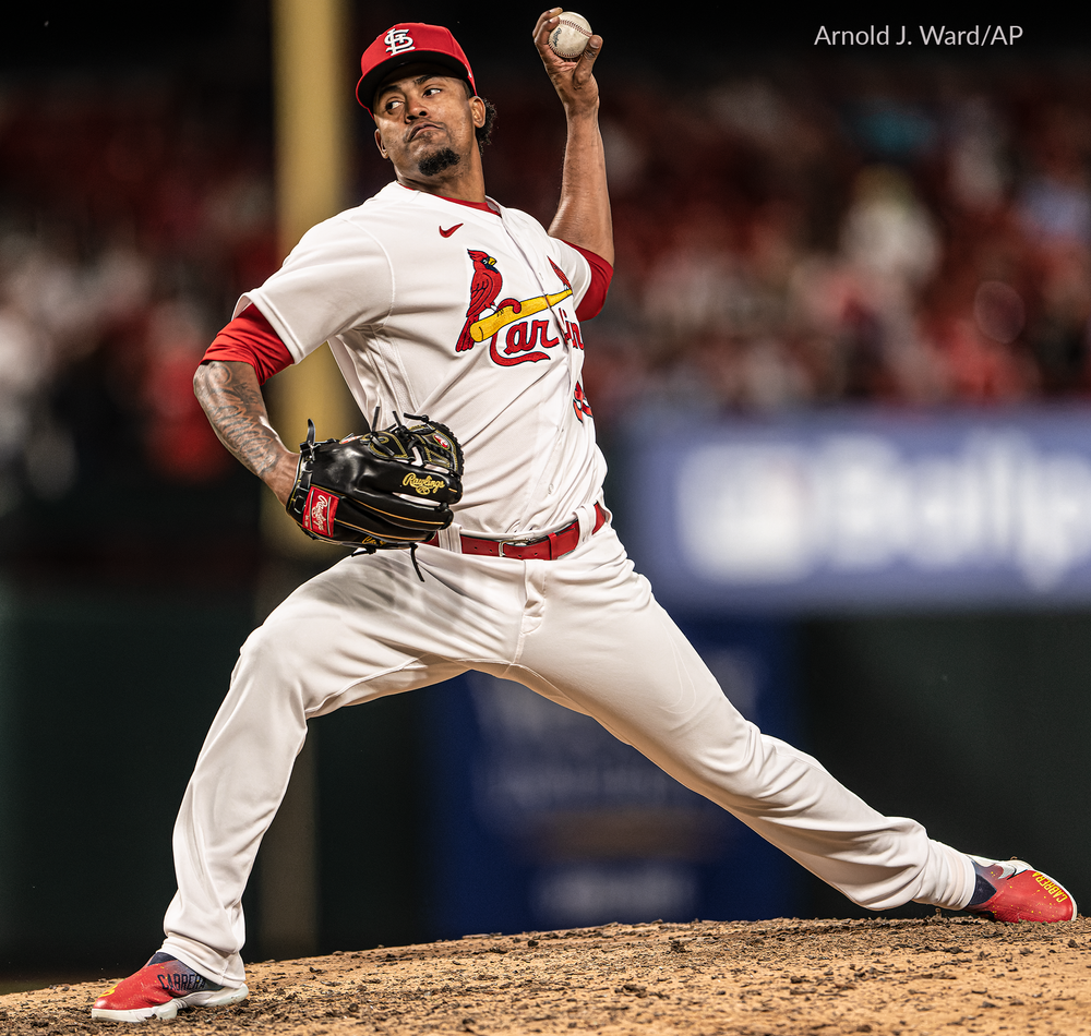 Cardinals pitcher in mid-delivery motion during a game at the stadium.