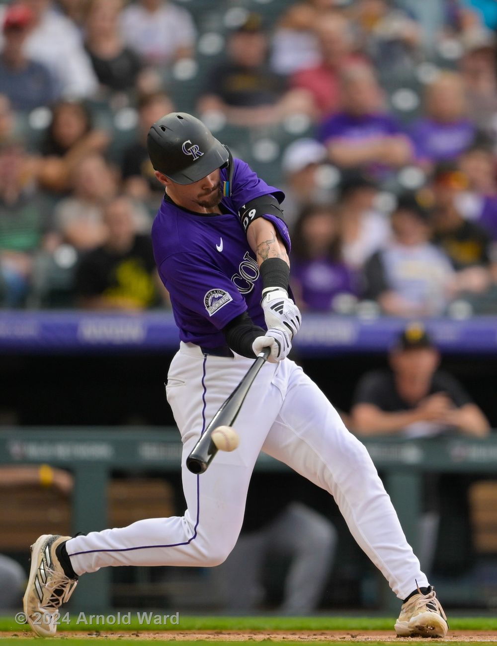 Colorado Rockies baseball player swings at pitch during game.