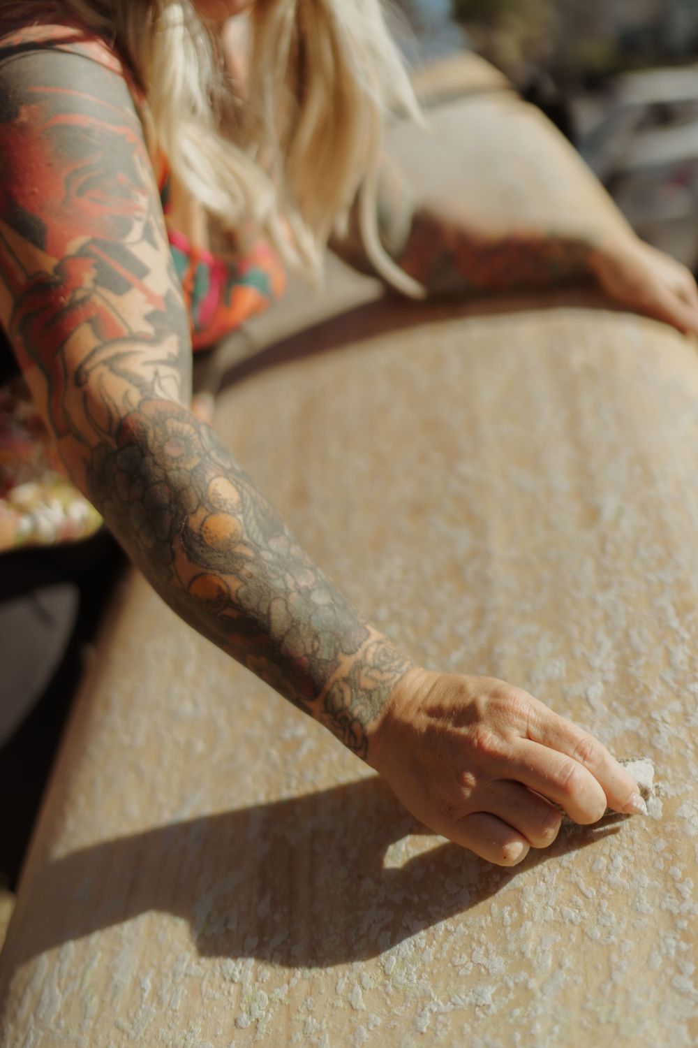 a woman waking her surfboard