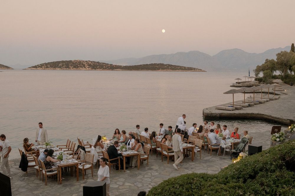 A panoramic collage of a beachfront restaurant setting at sunset with tables and guests overlooking the ocean.