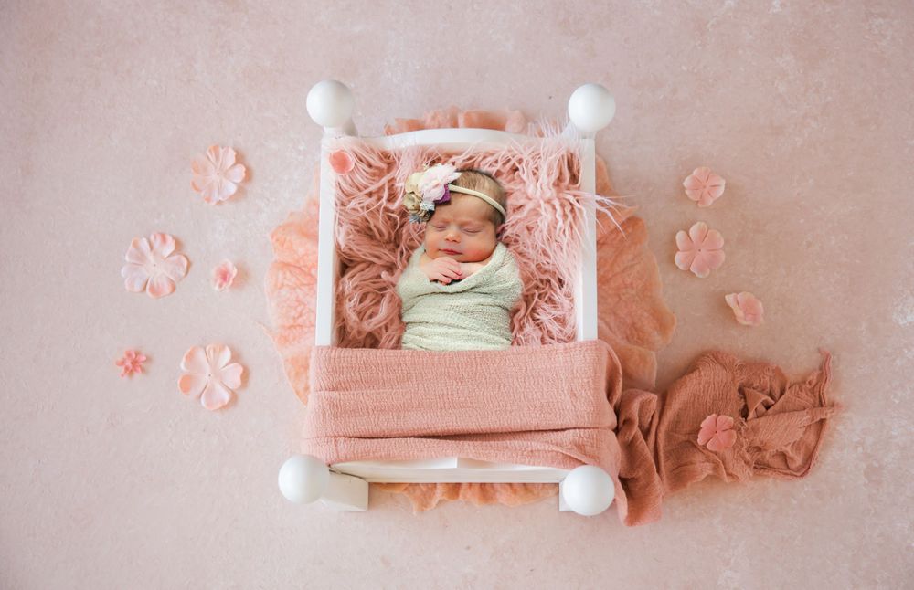 Newborn image in miniature poster bed