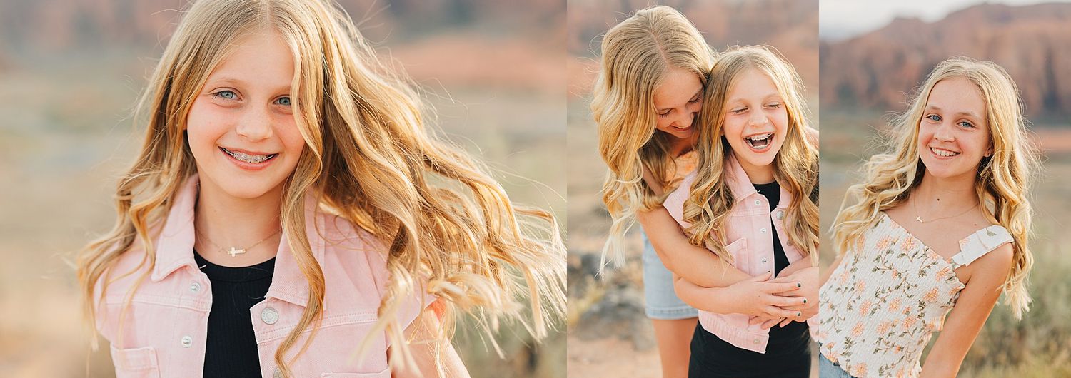 Two blonde girls laughing and posing together outdoors in a sunny desert landscape during a family photo session.