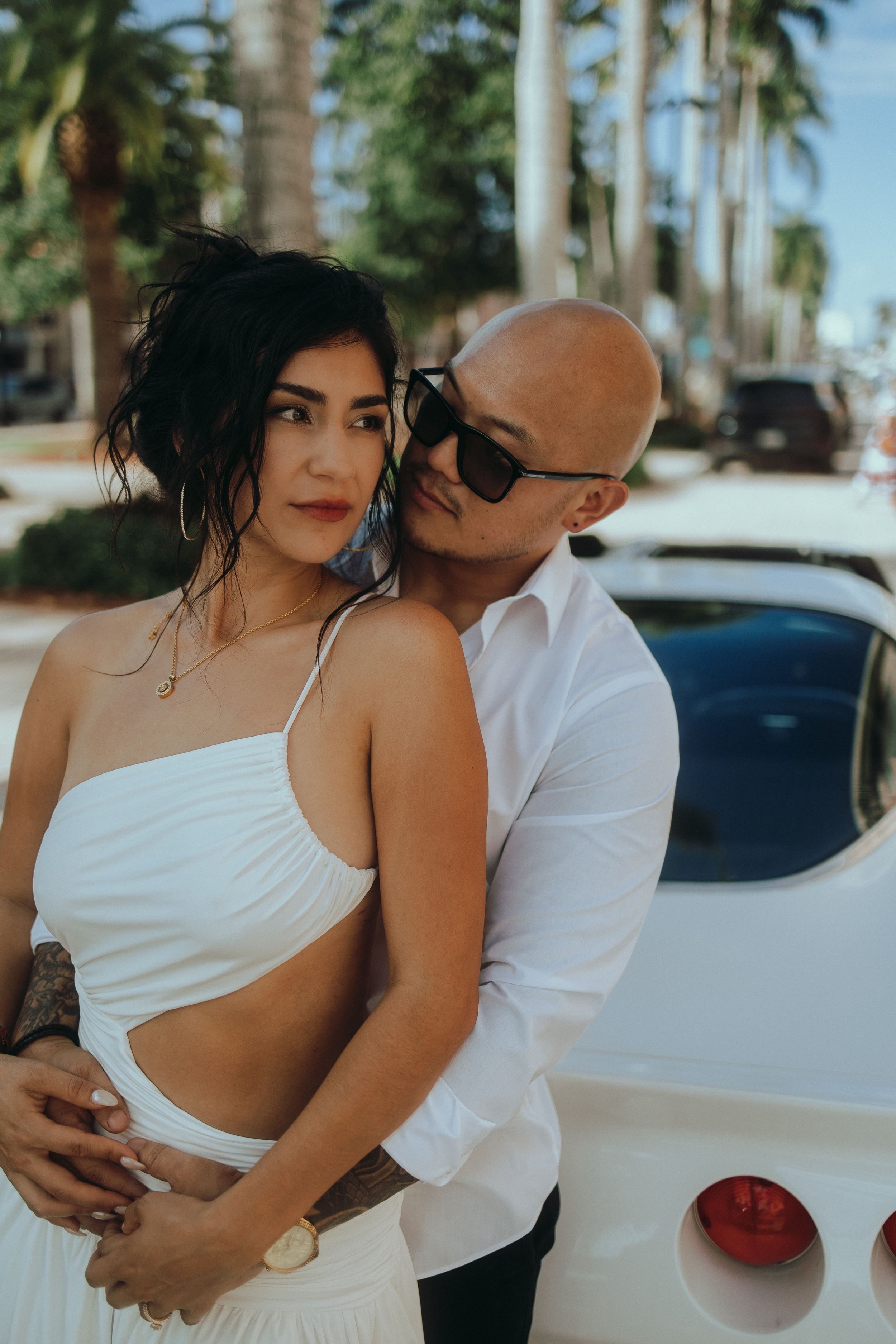 Stylish couple embracing during a cinematic outdoor portrait session in Miami captured by MannyPortraits