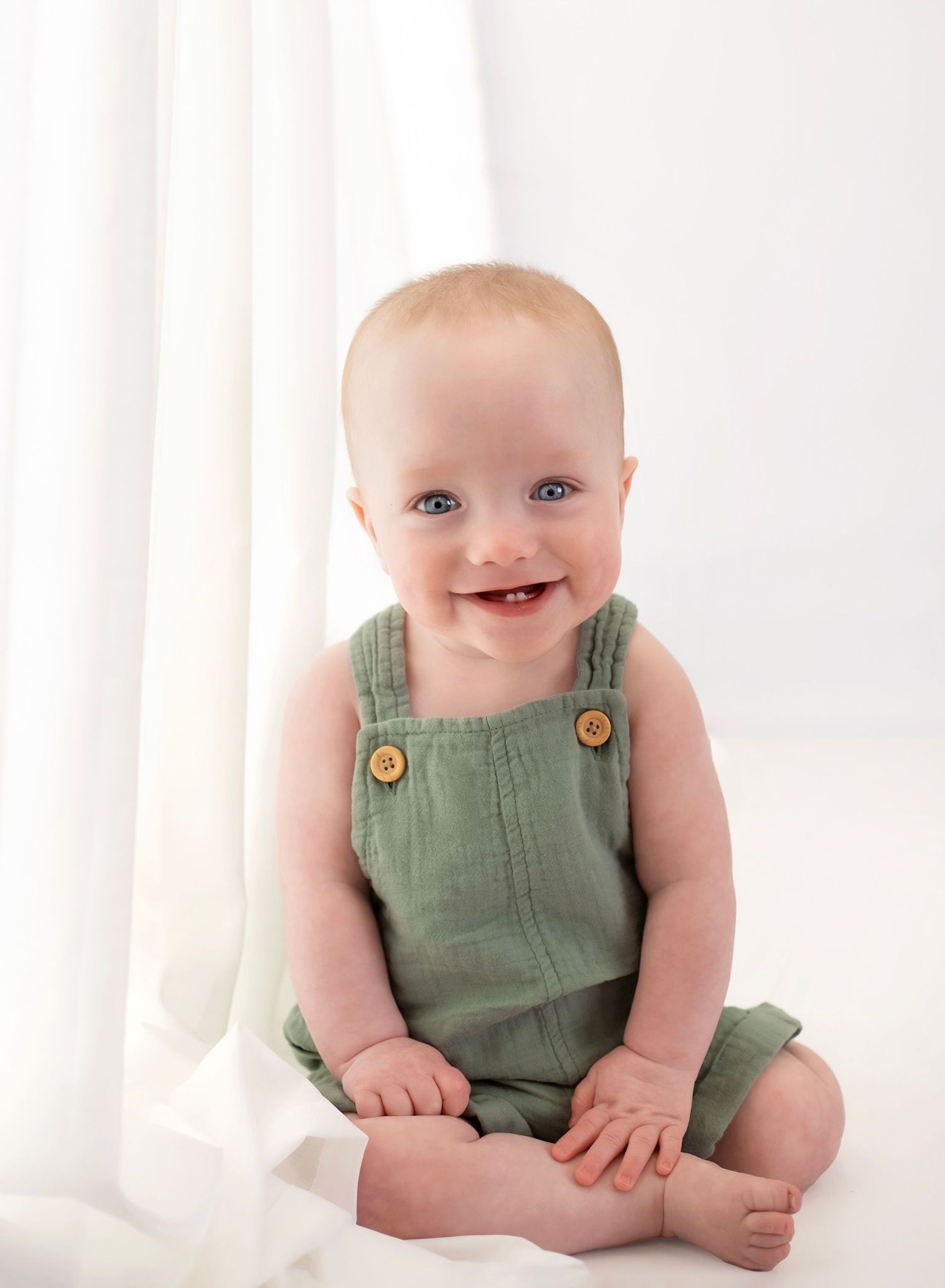 Baby in blue and gray striped outfit and matching beanie hat shown in multiple candid poses on white background.