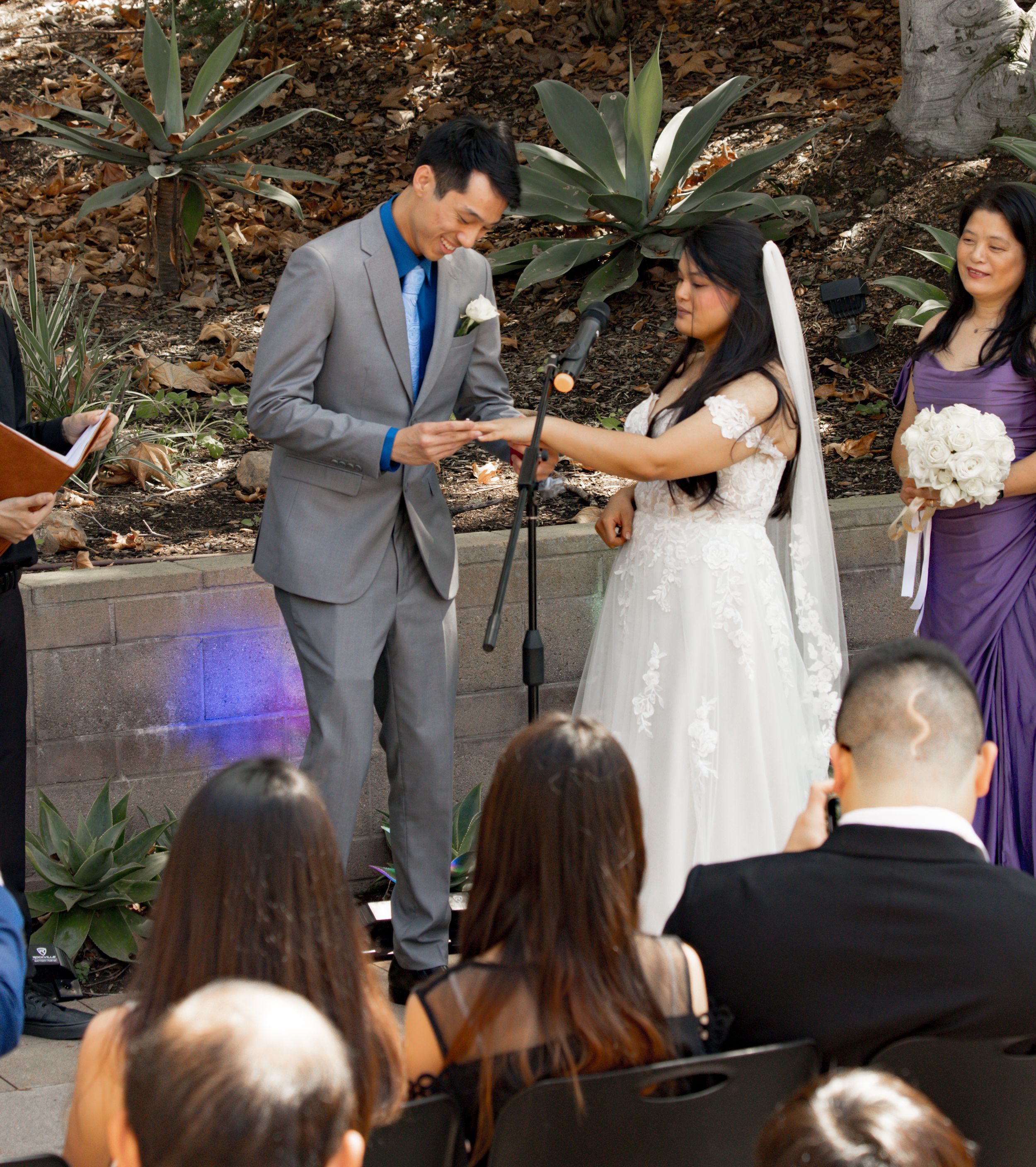 Bride and groom exchanging vows at their outdoor wedding ceremony by Zeus Holbrook San Diego Wedding Photographer