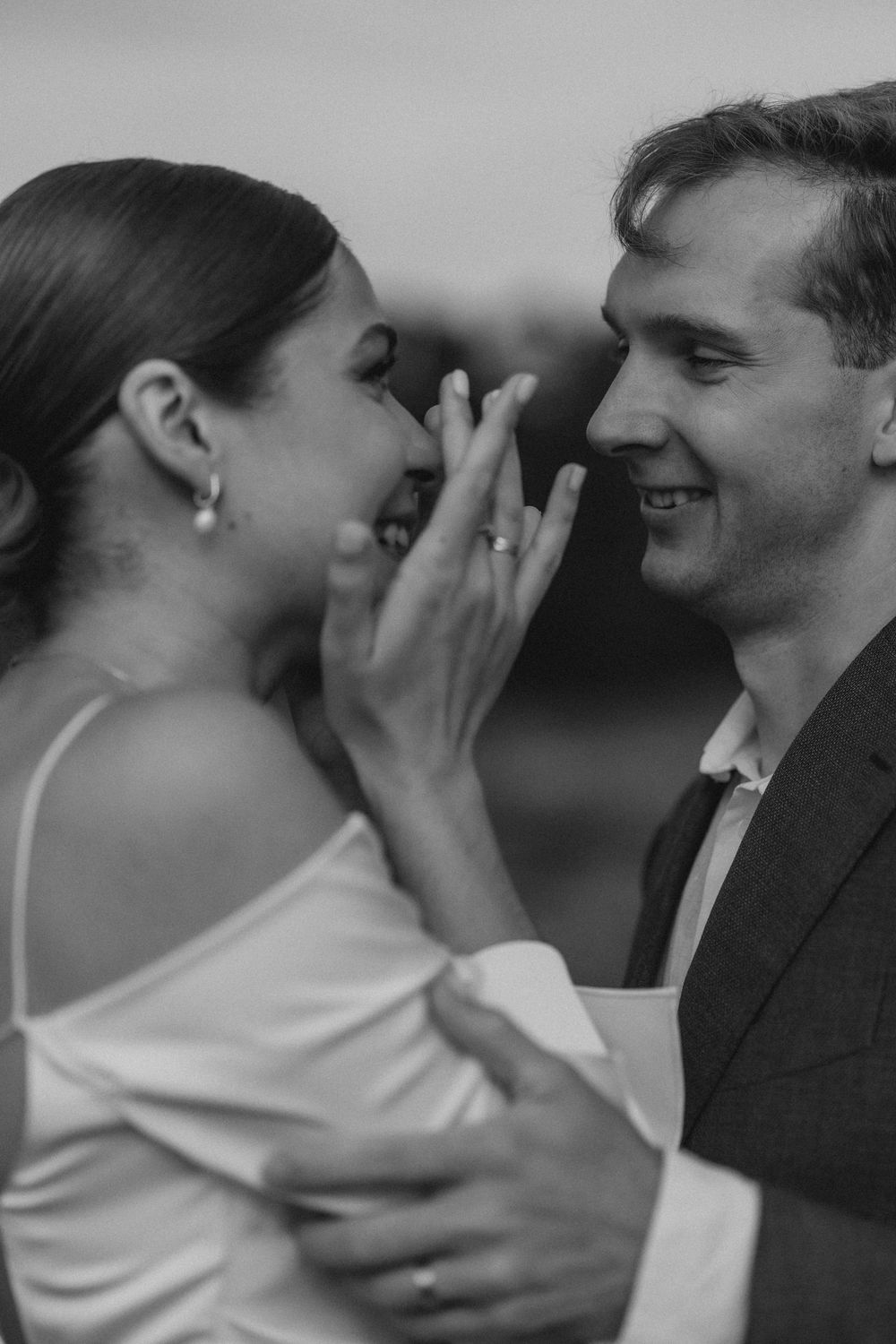 intimate black and white wedding portrait of bride and groom laughing together documentary elopement photography