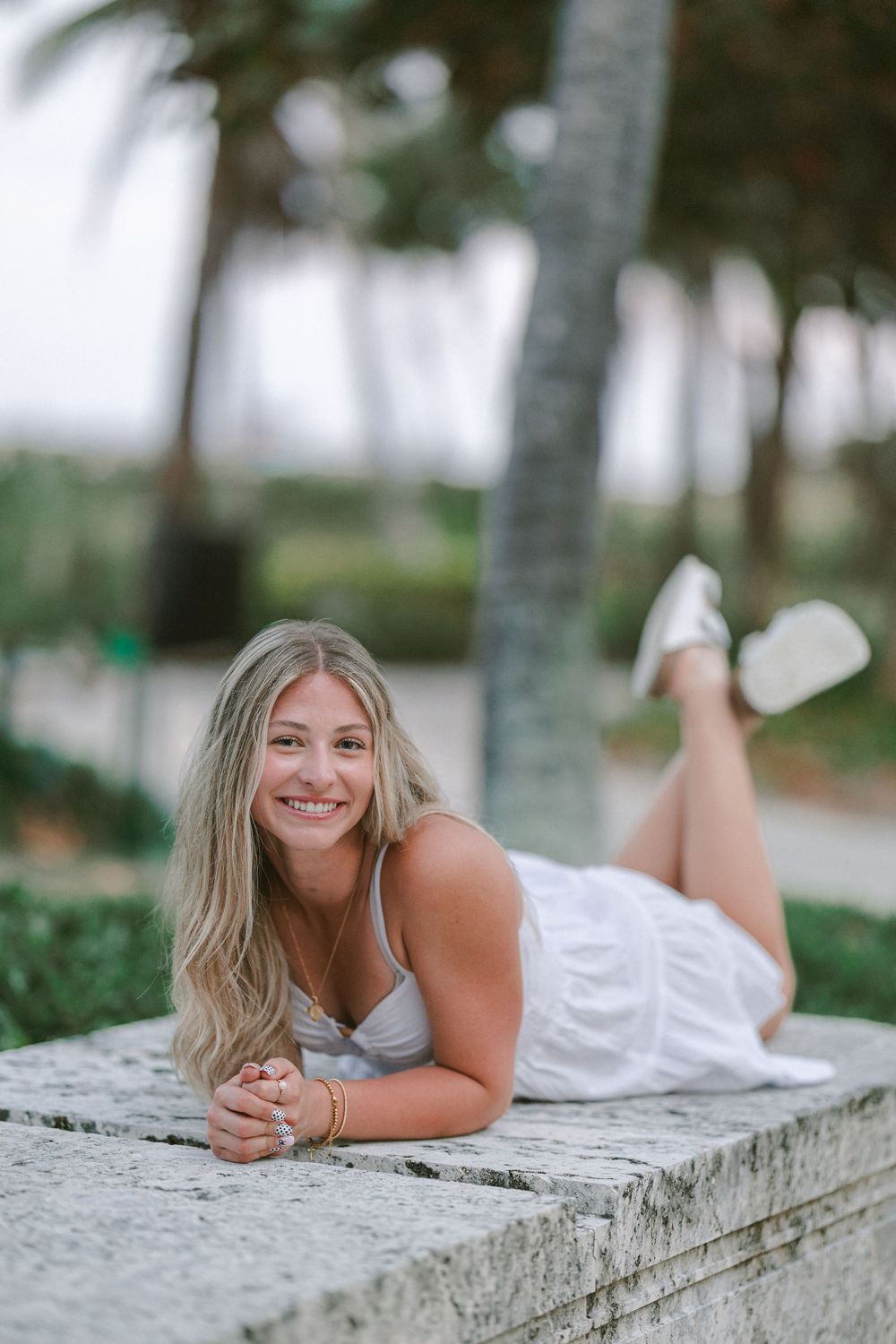 senior portrait laying down at pompano beach