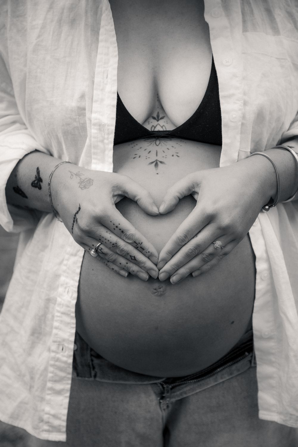 Cinematic maternity shoot with hand heart pose, 2025