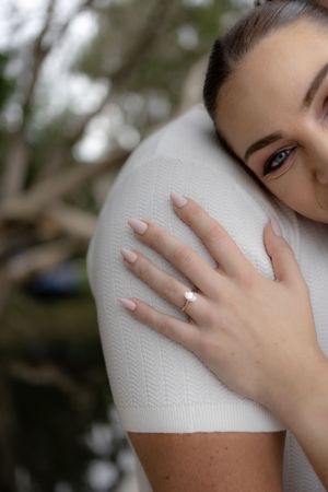 Close-up sequence showing hands gently touching and exploring white textured fabric against a blurred background.