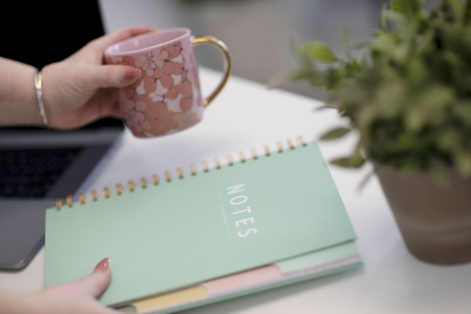 Photo of a cup of coffee and a notebook ready for planning.