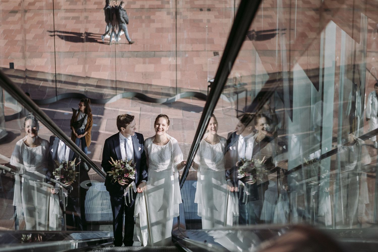 A black and white collage of wedding moments showing dancing, embraces, and celebrations in various outdoor settings.