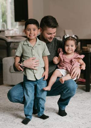 A sequence of candid family moments showing a young child and adult sitting together on a carpeted floor.