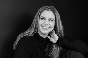 Black and white headshot portraits showing various expressions and poses against a dark background.