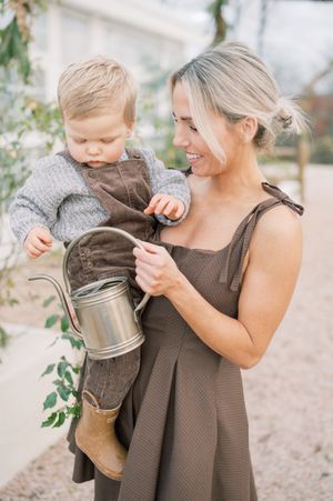 A series of candid moments showing a parent and toddler sharing playful interactions while holding a vintage watering can.