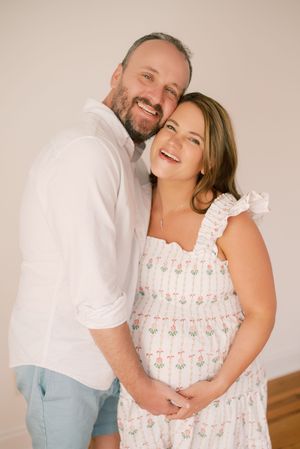A couple in white clothing share joyful laughter and intimate moments in a series of romantic portrait photos.