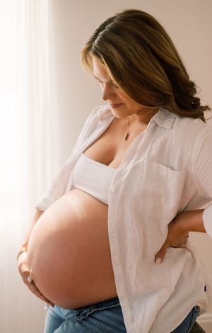 A series of maternity photos showing a pregnant woman in a white button-down shirt lifting it to reveal her belly.