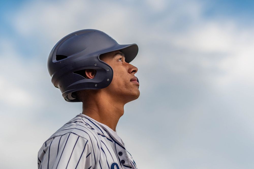 CJ Cuevas, a Conwell-Egan Catholic High School baseball player, wearing a batting helmet and looking up toward the sky.