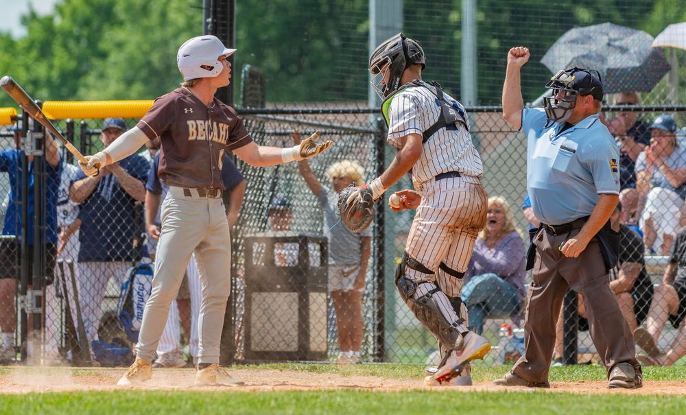 A Bethlehem Catholic High School player looks back at the umpire after being called out on strikes against Conwell-Egan Catholic High School