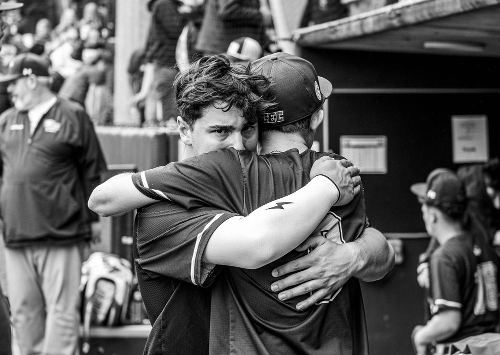 A black and white photo of Conwell-Egan Catholic High School baseball player Connor Landau hugging another player.