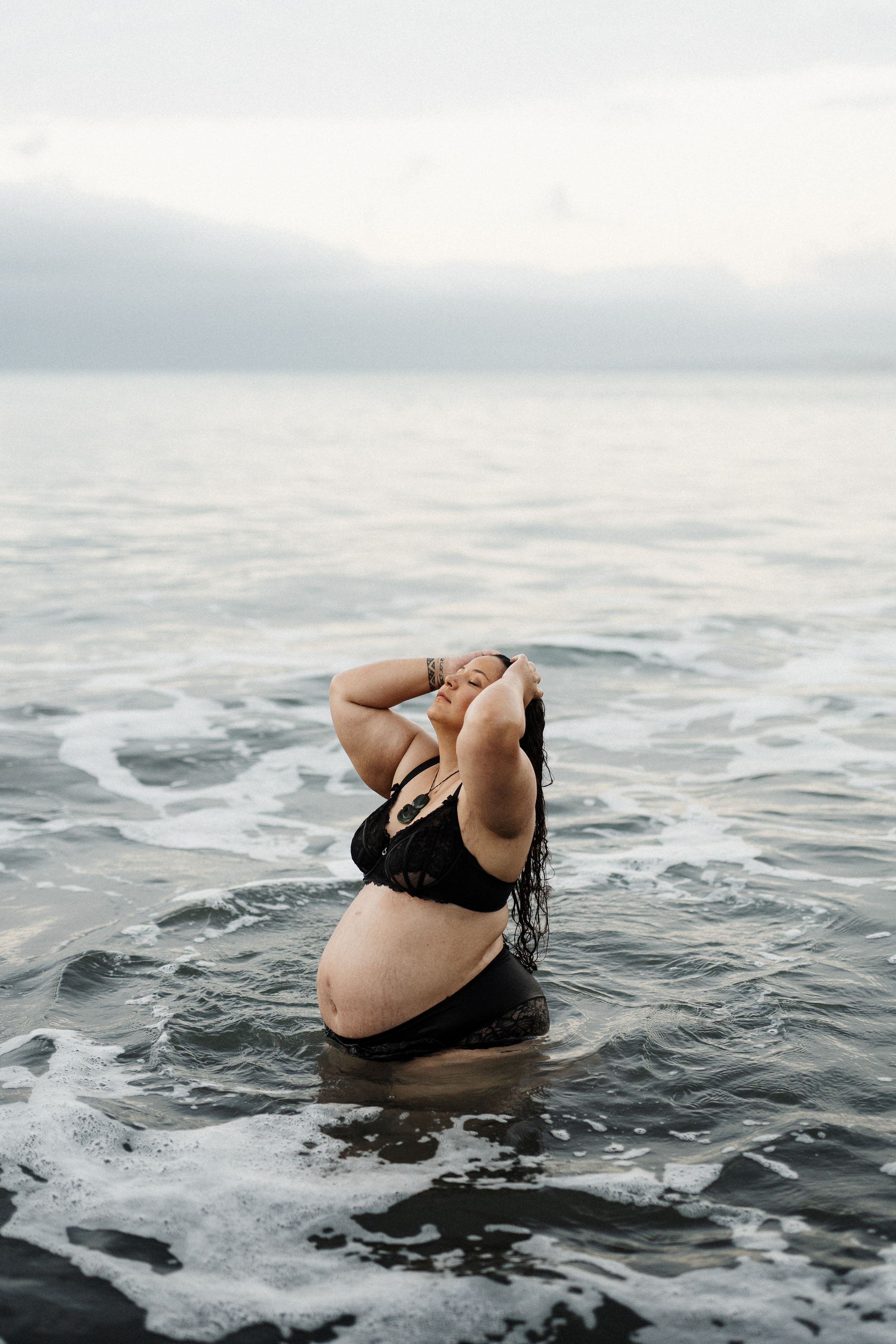 Person enjoying a peaceful moment while swimming in dark ocean waters.