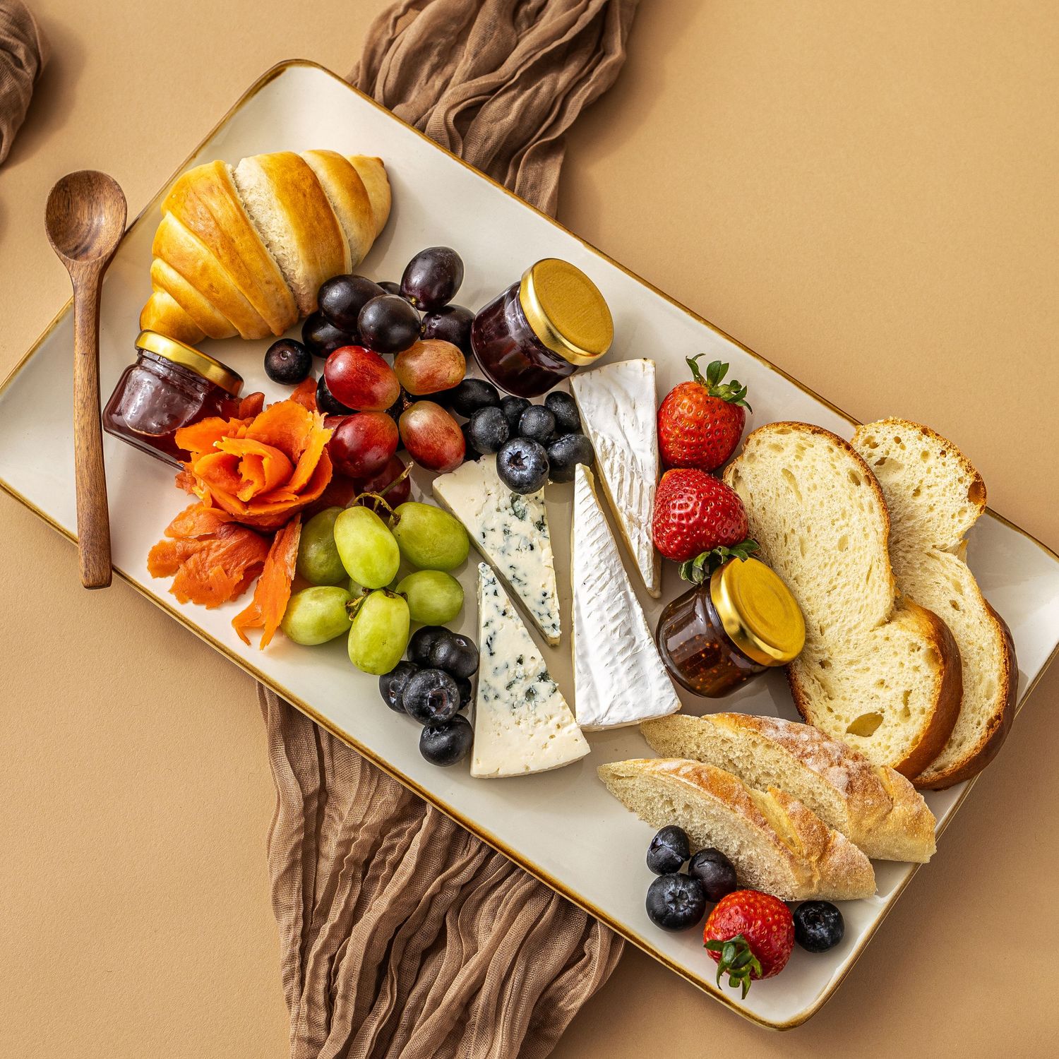 Hero shot of a German charcuterie platter with scratch made bread, fresh fruit, and cheese by Heartbakn catering in New Braunfels Texas
