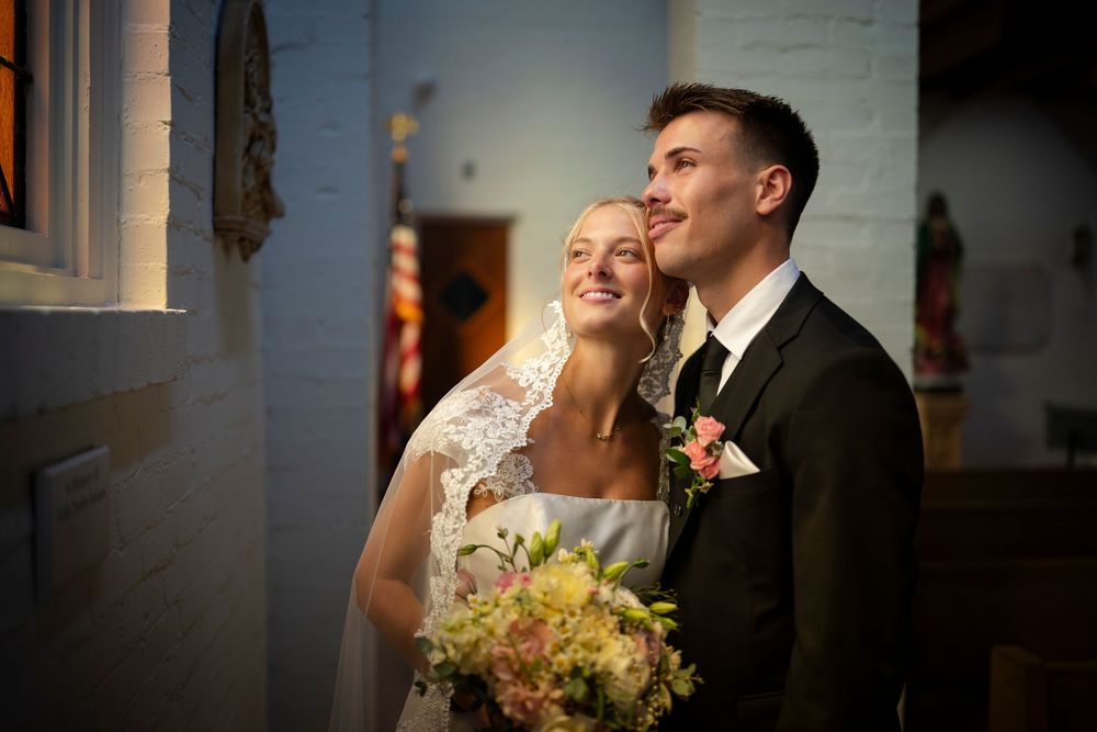 Joyful wedding couple shares intimate candid moments and laughter together during photo session.