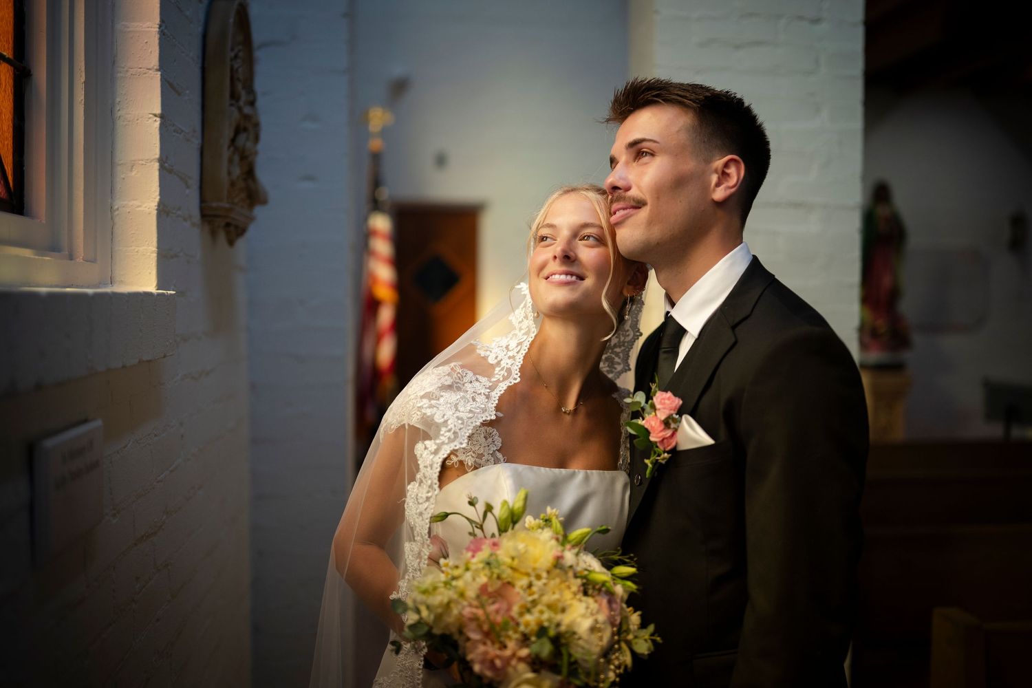 Joyful wedding couple shares intimate candid moments and laughter together during photo session.