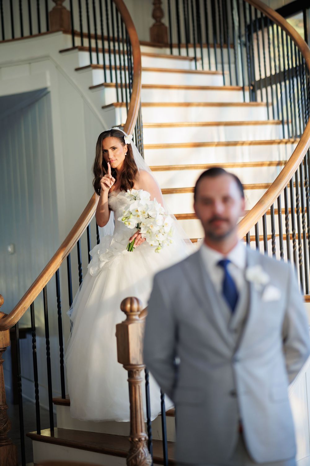 A creative first look photo sequence showing a bride and groom meeting before their ceremony near a staircase.