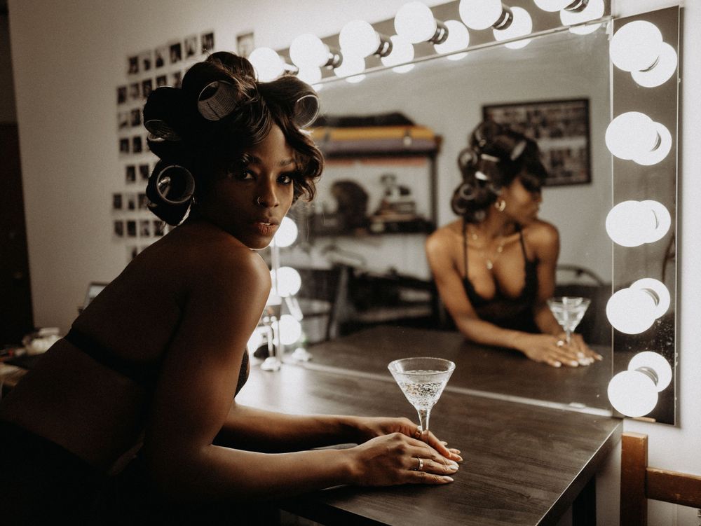 Glamorous vanity mirror scene with classic Hollywood lighting and a martini glass.