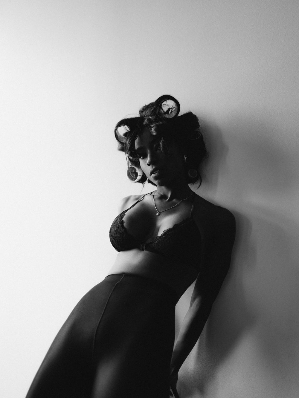 Film noir inspired portrait with dramatic shadows and vintage styling.