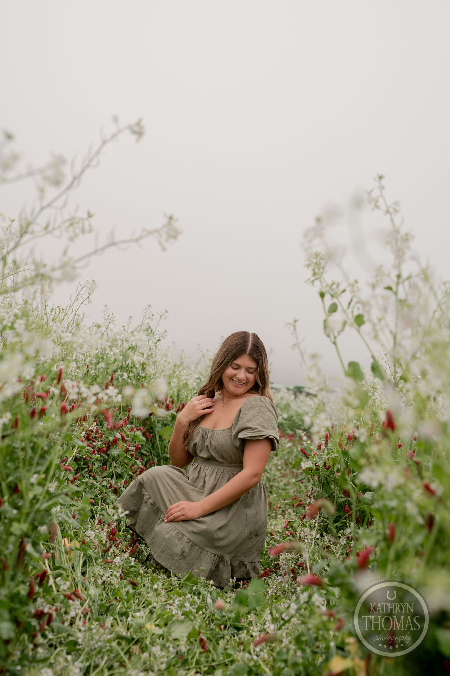 A charming portrait in a wildflower meadow with someone wearing a ruffled olive-green dress.