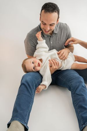 First aid steps demonstrated for helping a choking infant using back blows shown in sequential photos on white background.
