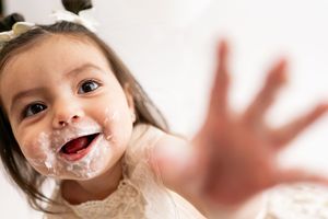 Playful image of someone with whipped cream or foam smeared on their nose shown from different joyful angles.