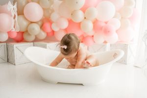 Pink and white balloon garland wedding decor with floral arrangements and soft romantic lighting.