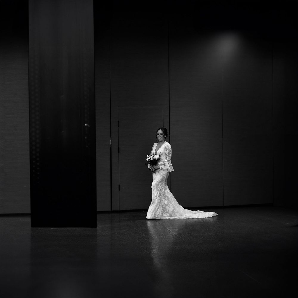 Dramatic black and white sequence of couple's first dance in empty ballroom.