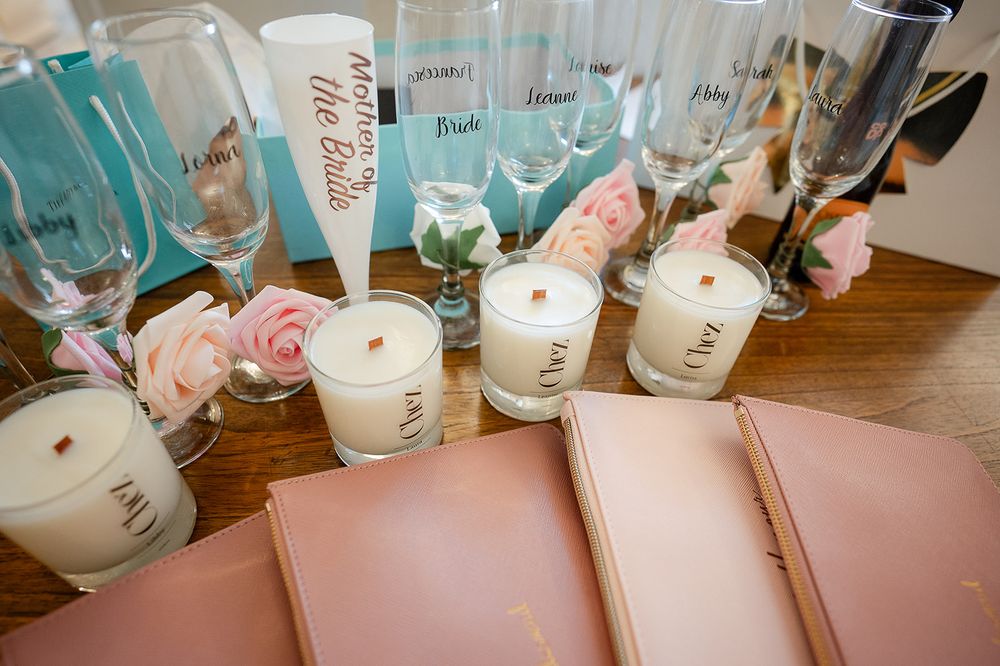 Wedding decor with pink florals, candles and champagne glasses.