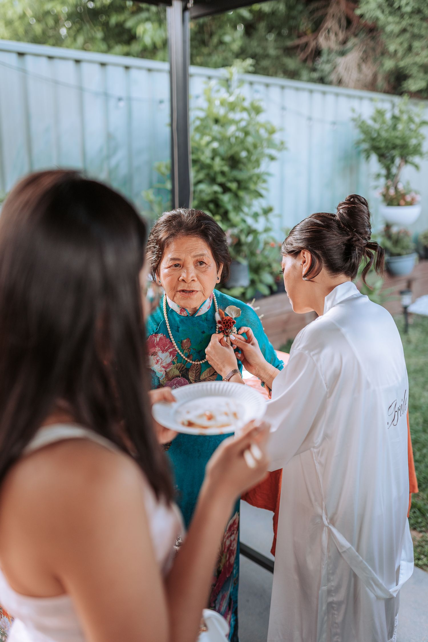 Friends gather outdoors for a casual meal and conversation on a summer evening.