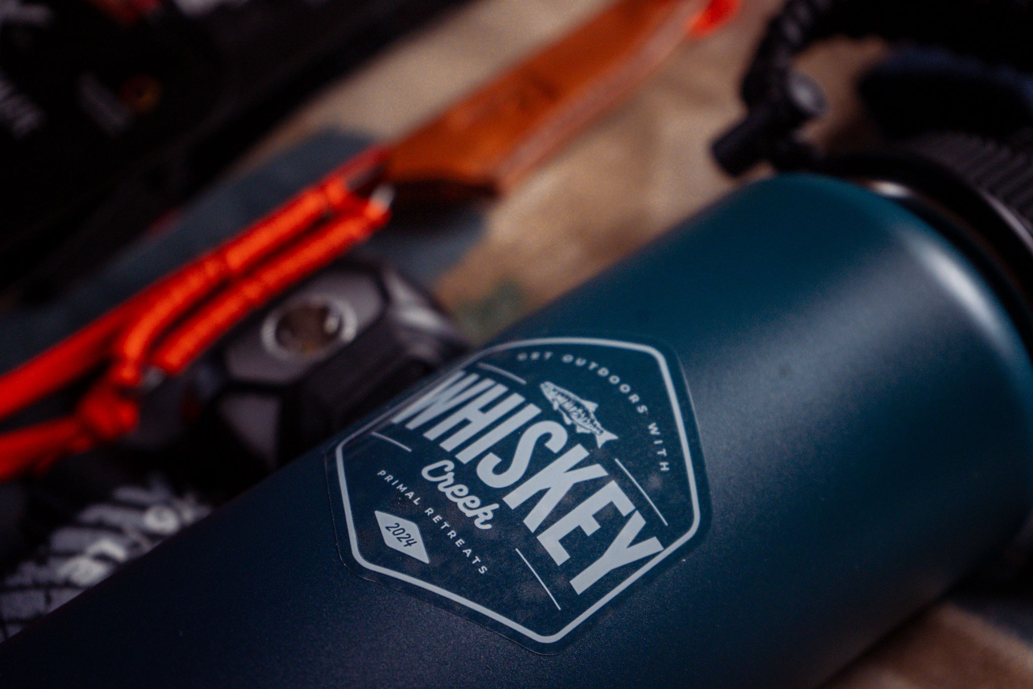 Close-up of a dark blue water bottle with Wasatch Brewery logo visible against blurred background.
