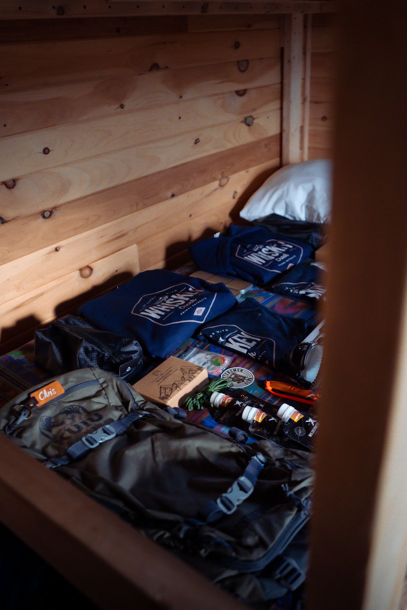 Navy blue clothing and merchandise items laid out on wooden shelves in what appears to be a retail storage space.