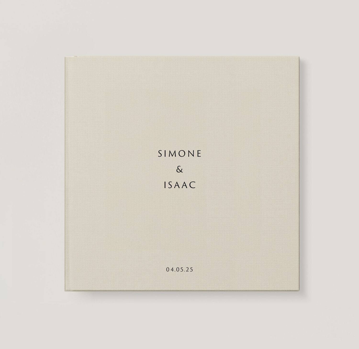 A simple beige hardcover book with gold text embossing on the cover sits against a speckled light background.