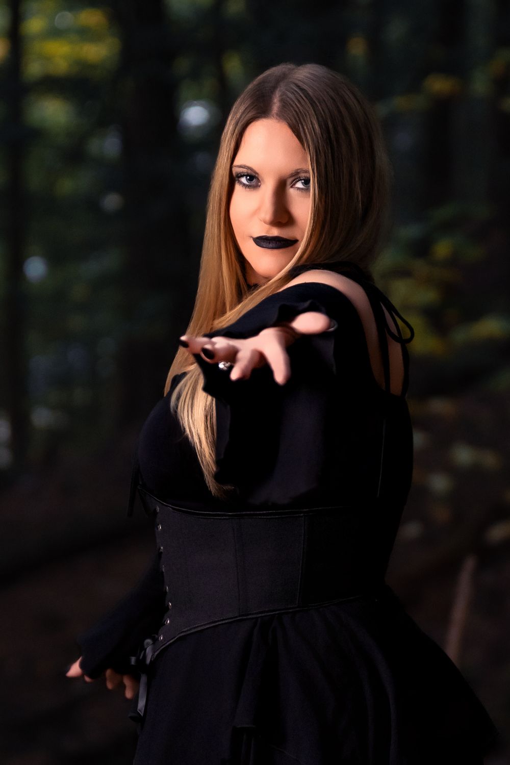 A series of moody portraits showing a person in black clothing against a dark forest background.