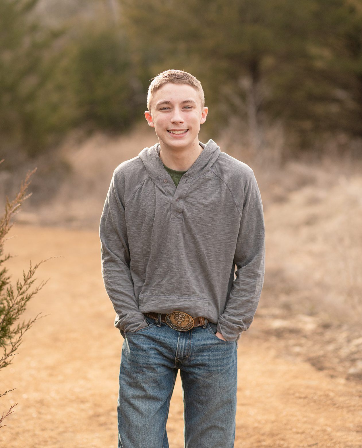 Senior guy portrait session in a late winter field and with his car by Kristi Bray Photography