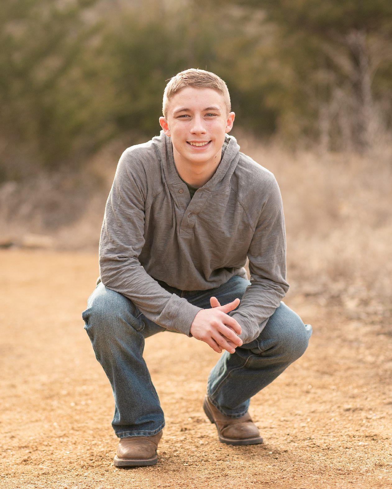 Senior guy portrait session in a late winter field and with his car by Kristi Bray Photography